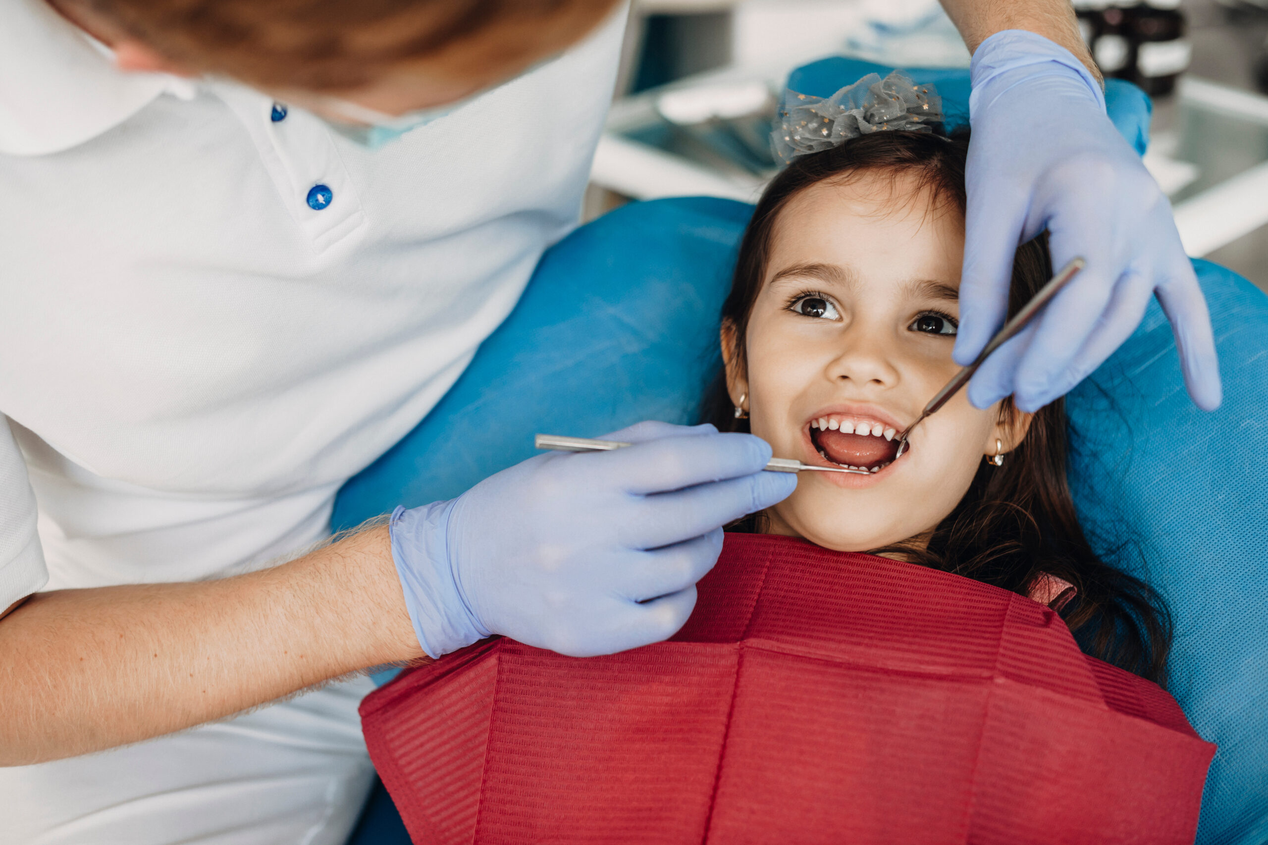 Pediatric dentist checking a child's teeth